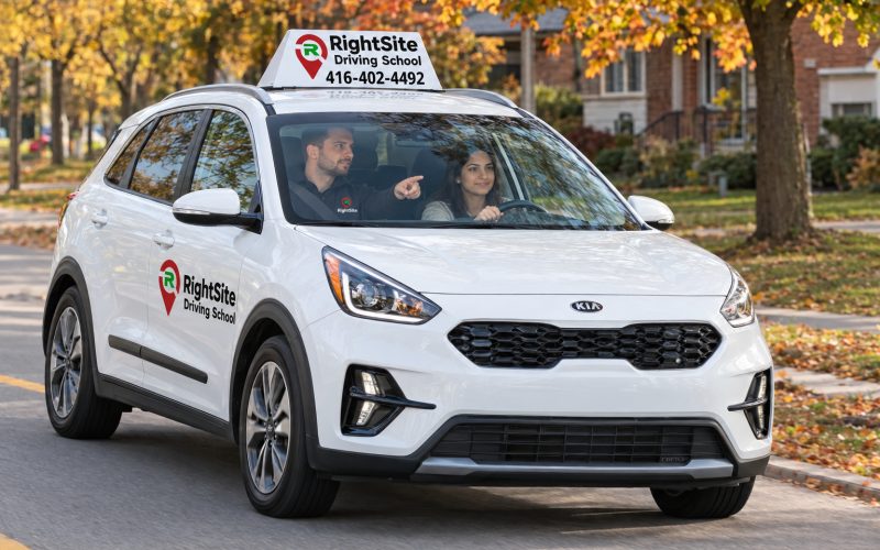 A student driving the RightSite car while the instructor points ahead
